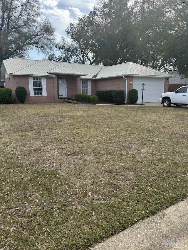 ranch-style home featuring an attached garage, brick siding, and a front yard