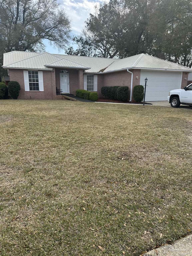 single story home with a front lawn, brick siding, metal roof, and an attached garage