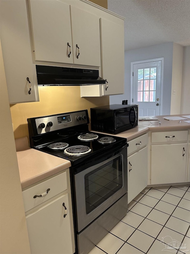 kitchen with black microwave, under cabinet range hood, a textured ceiling, and stainless steel range with electric cooktop