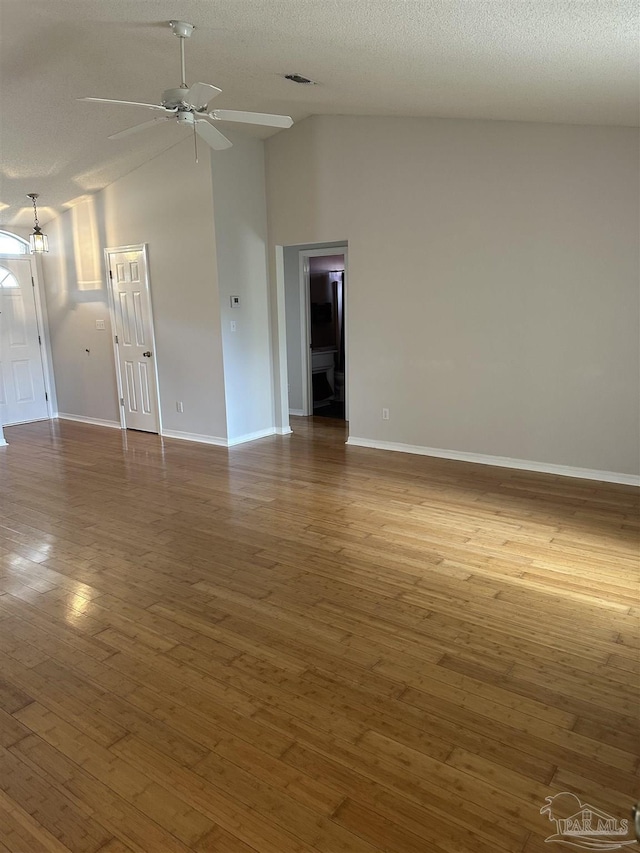 spare room with ceiling fan, wood finished floors, visible vents, and baseboards