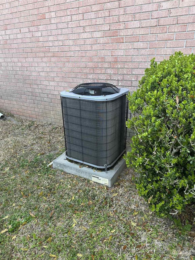 exterior details with central AC and brick siding