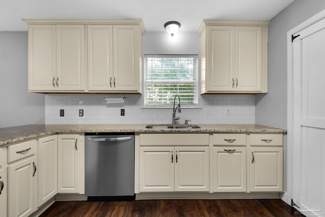 kitchen featuring dishwasher, cream cabinets, sink, and light stone counters