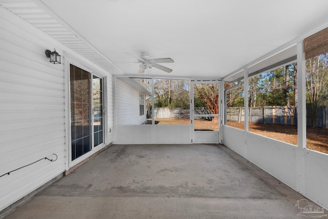 unfurnished sunroom with ceiling fan