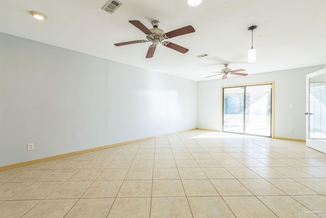 spare room with ceiling fan and light tile patterned flooring