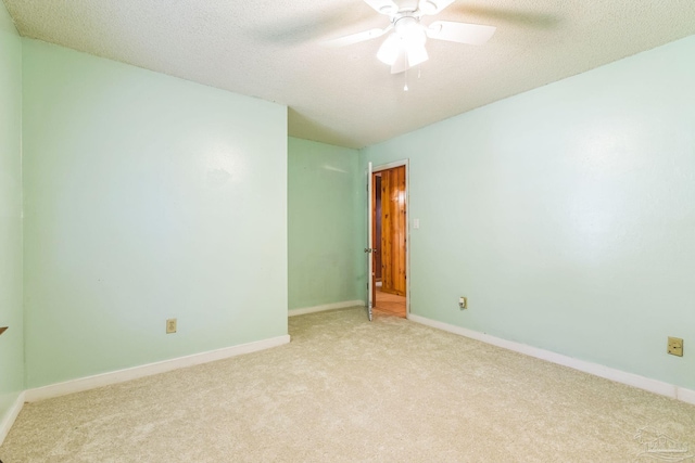 carpeted empty room featuring a textured ceiling and ceiling fan