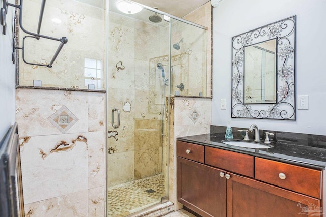 bathroom with vanity and a shower with shower door