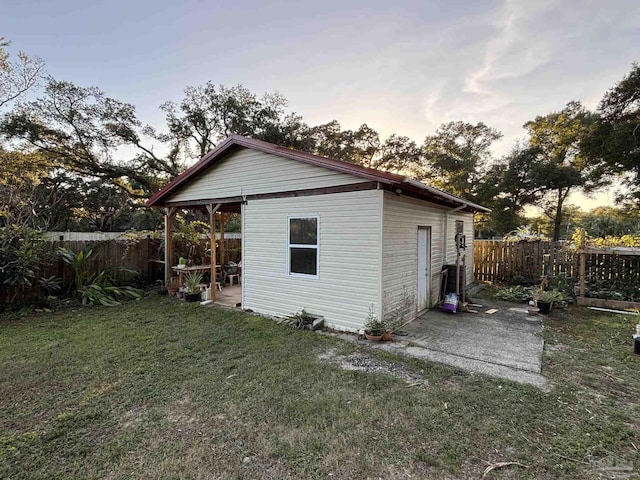 exterior space with an outdoor structure and a lawn