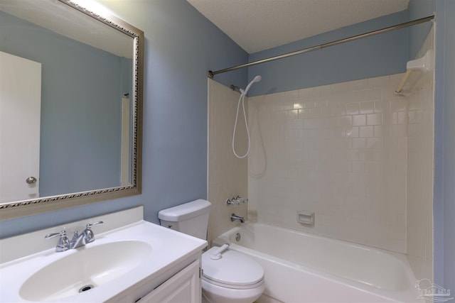 full bathroom with tiled shower / bath, vanity, a textured ceiling, and toilet