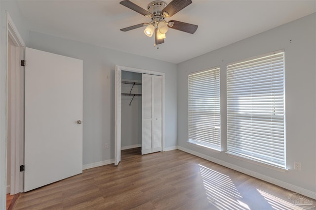 unfurnished bedroom featuring light hardwood / wood-style floors, a closet, and ceiling fan