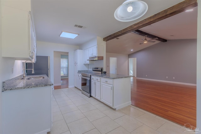 kitchen featuring light stone countertops, appliances with stainless steel finishes, and white cabinets