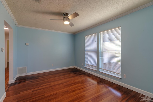 empty room with ornamental molding, dark hardwood / wood-style floors, a textured ceiling, and a wealth of natural light