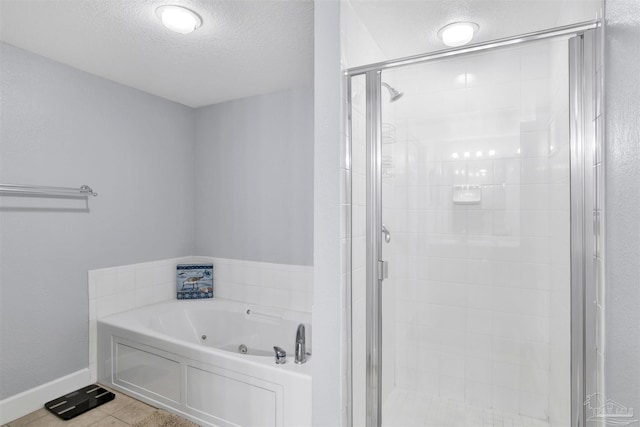 154 Ethel Wingate Dr Unit 109, Pensacola, FL 32507 - bathroom featuring a textured ceiling, separate shower and tub, and tile patterned flooring