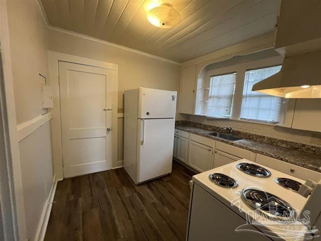 kitchen with white appliances, dark wood finished floors, wooden ceiling, ornamental molding, and a sink