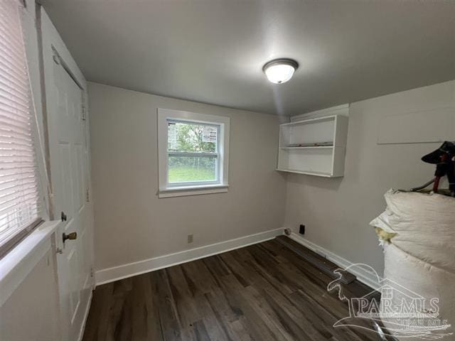 washroom with dark wood finished floors and baseboards