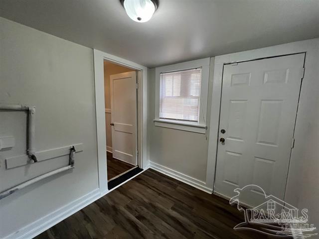 interior space with dark wood finished floors and baseboards