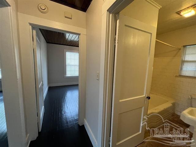 full bathroom featuring wood finished floors, bathtub / shower combination, and baseboards