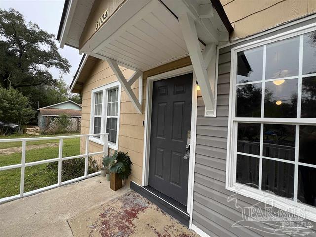 doorway to property featuring a yard