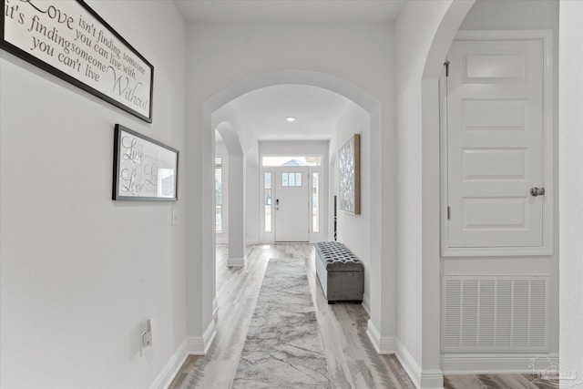 corridor with light hardwood / wood-style floors