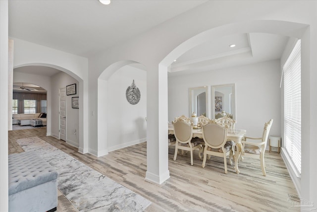 dining space with light hardwood / wood-style floors and ceiling fan