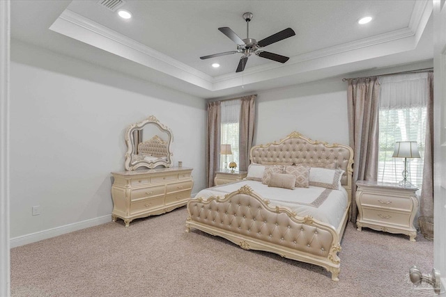 bedroom with ceiling fan, ornamental molding, a raised ceiling, and carpet