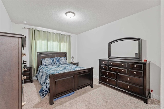 carpeted bedroom with a textured ceiling