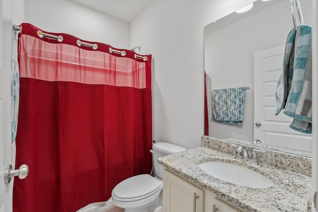 bathroom with a shower with curtain, vanity, and toilet