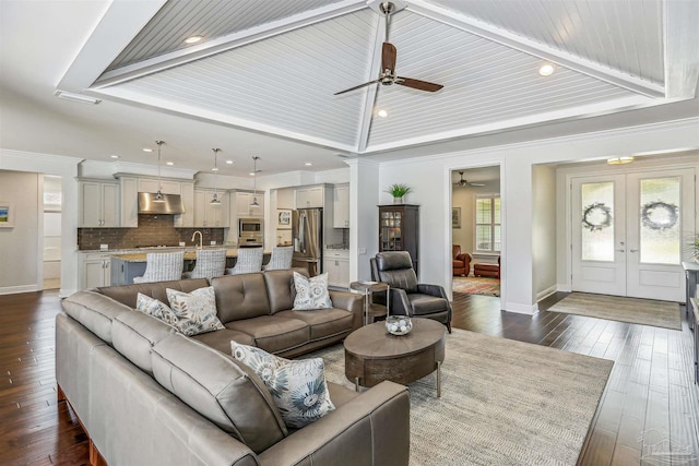 living area with ceiling fan, french doors, recessed lighting, baseboards, and vaulted ceiling