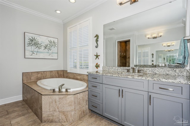 bathroom featuring vanity, ornamental molding, baseboards, recessed lighting, and a bath