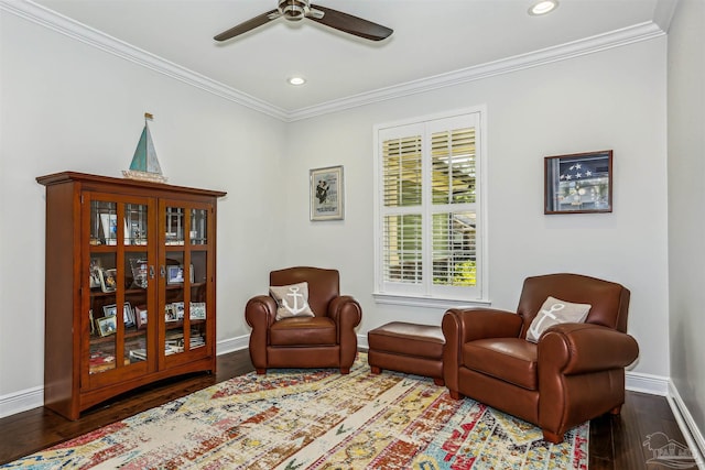 living area with crown molding, baseboards, a ceiling fan, and wood finished floors