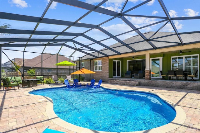 view of swimming pool featuring a patio, a fenced in pool, a ceiling fan, a lanai, and outdoor dining space