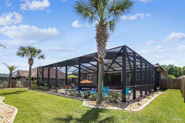 view of yard featuring a fenced backyard, a fenced in pool, and a lanai