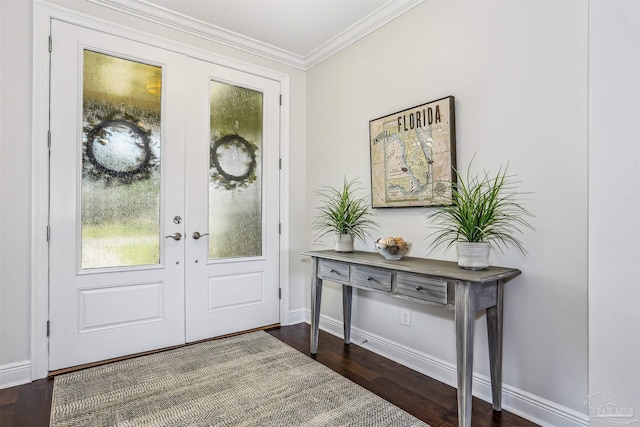 foyer entrance with french doors, ornamental molding, baseboards, and dark wood-type flooring