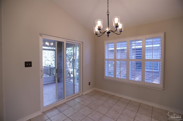 tiled spare room with a chandelier and vaulted ceiling