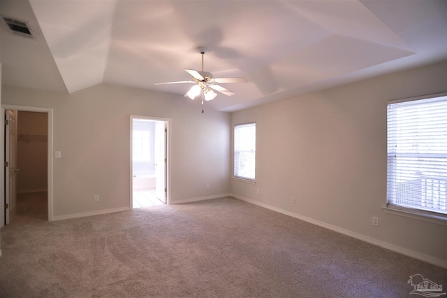 carpeted empty room with ceiling fan and lofted ceiling