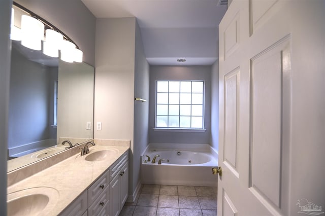 bathroom with a tub, tile patterned flooring, and vanity