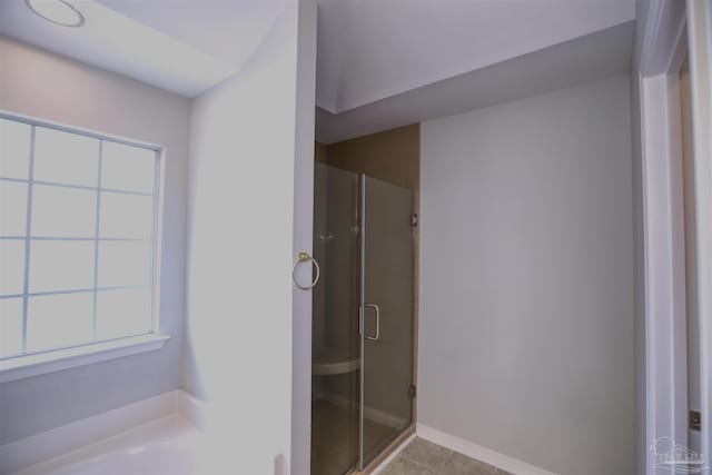 bathroom with tile patterned flooring and independent shower and bath