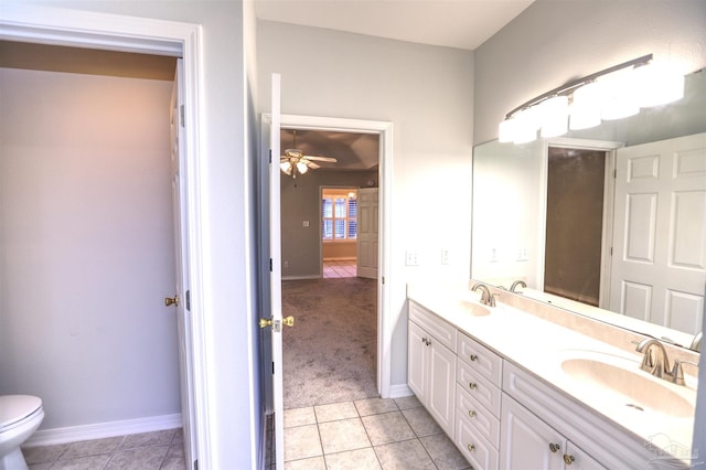 bathroom featuring toilet, vanity, tile patterned floors, and ceiling fan