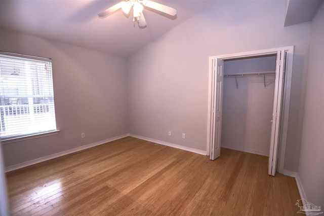 unfurnished bedroom with a closet, light hardwood / wood-style flooring, ceiling fan, and lofted ceiling