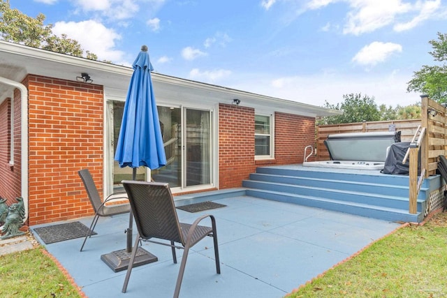 view of patio / terrace featuring a covered hot tub