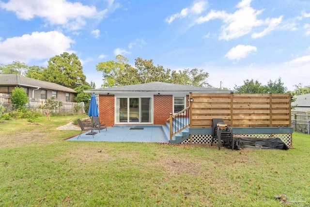 back of house featuring a yard and a patio area