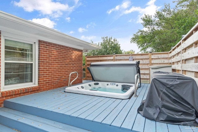 wooden terrace featuring a covered hot tub