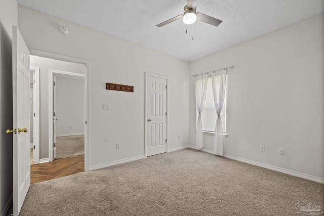 unfurnished bedroom with baseboards, a textured ceiling, and carpet flooring