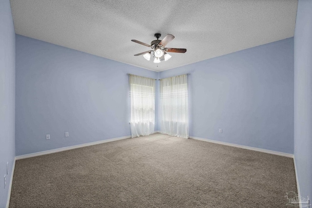 unfurnished room with a textured ceiling, ceiling fan, baseboards, and carpet floors