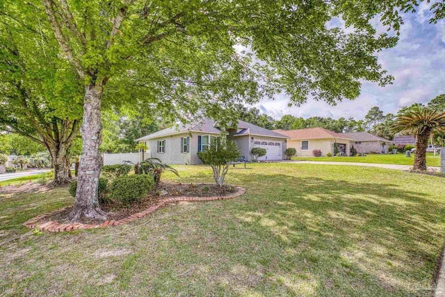 ranch-style home featuring fence, a front lawn, and an attached garage
