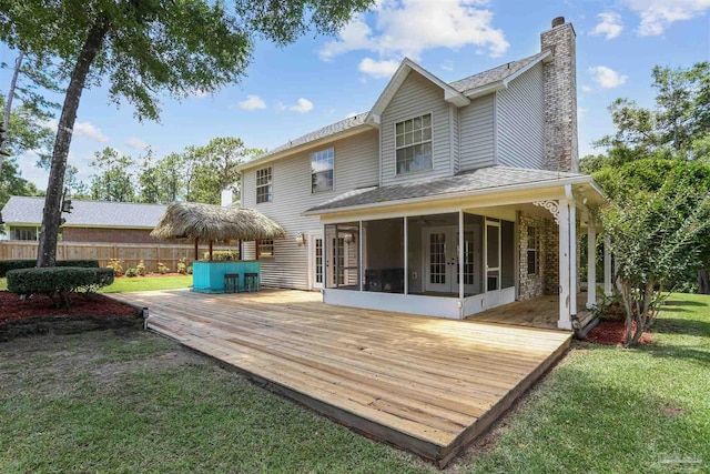 2724 Ashbury Ln, Cantonment, FL 32504 - rear view of property featuring a sunroom, a deck, a chimney, and roof with shingles