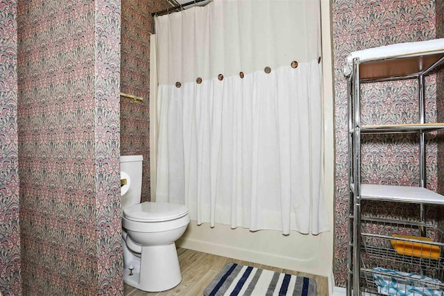 2724 Ashbury Ln, Cantonment, FL 32504 - full bathroom featuring wood finished floors, shower / bathtub combination with curtain, and wallpapered walls