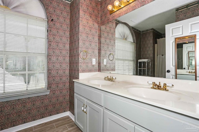 2724 Ashbury Ln, Cantonment, FL 32504 - bathroom featuring double vanity and wood finished floors