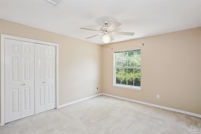 2724 Ashbury Ln, Cantonment, FL 32504 - unfurnished bedroom featuring carpet floors, a closet, a ceiling fan, and a textured ceiling
