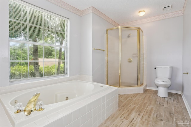 2724 Ashbury Ln, Cantonment, FL 32504 - bathroom featuring a shower stall, a whirlpool tub, plenty of natural light, a textured ceiling, and wood finished floors