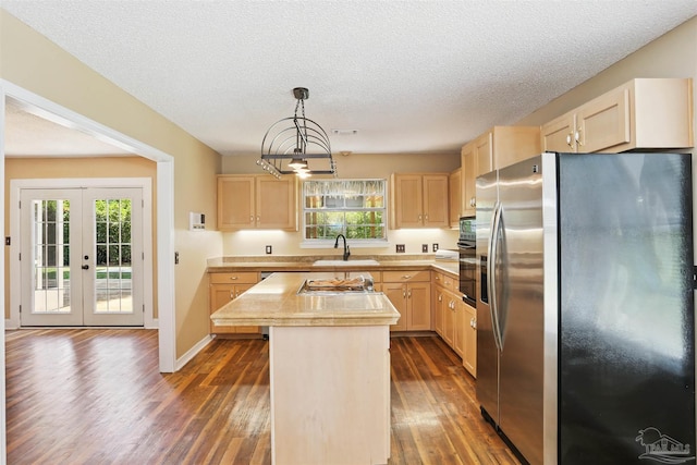 2724 Ashbury Ln, Cantonment, FL 32504 - kitchen with stainless steel appliances, light brown cabinetry, dark wood-style floors, plenty of natural light, and a textured ceiling